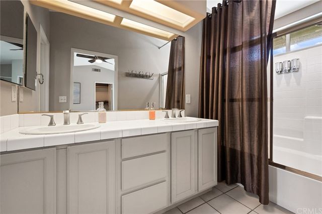a bathroom with a double vanity sink and a mirror