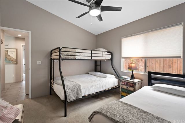 a bedroom with two beds and window