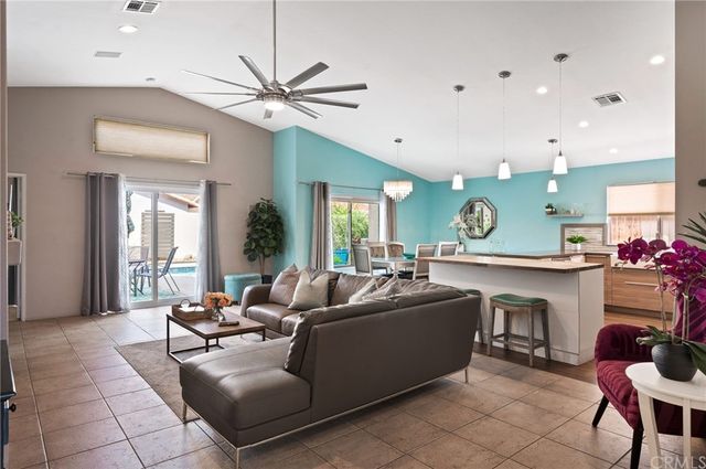 a living room with fireplace furniture and a large window