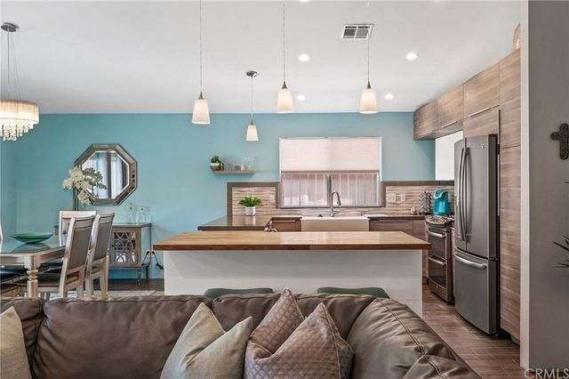 a kitchen with stainless steel appliances granite countertop a sink a stove and a refrigerator