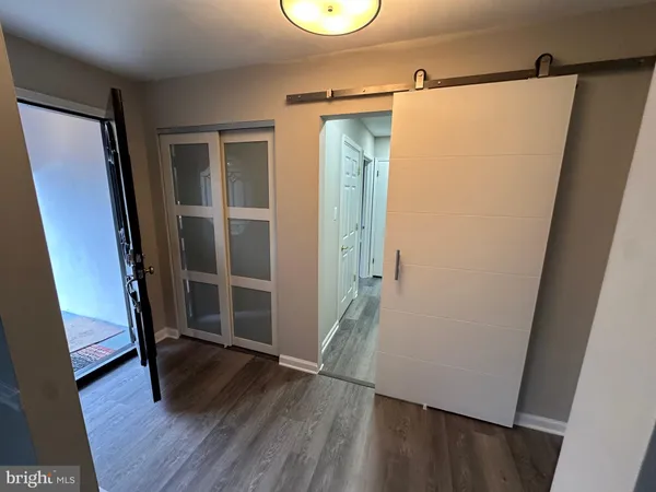 a view of walk in closet with wooden floor