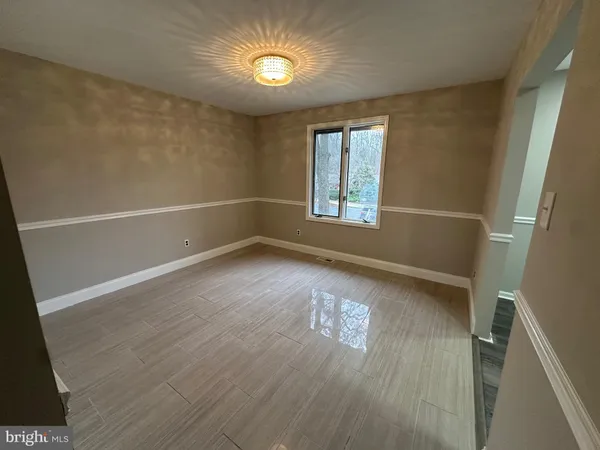 a view of room with window and hardwood floor