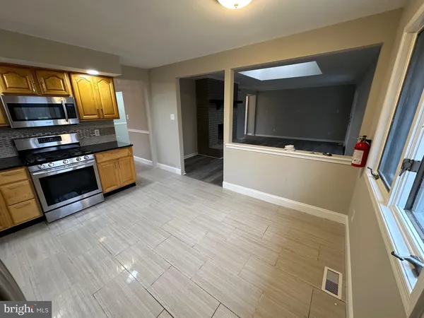 a kitchen with granite countertop a refrigerator and a stove