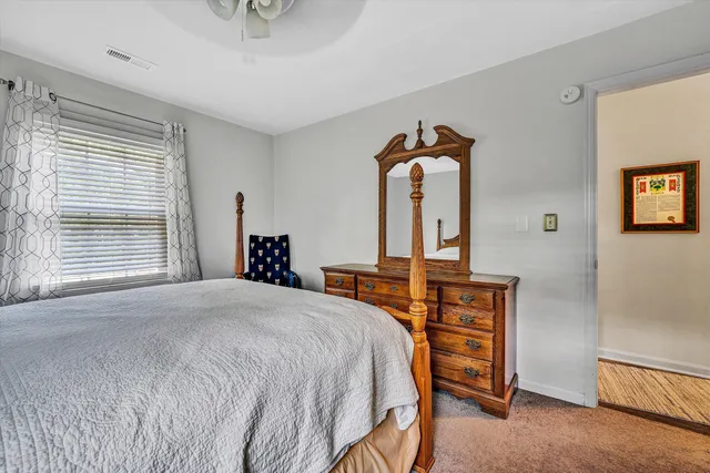 a bedroom with a bed and a dresser in it