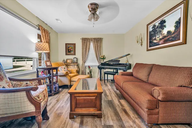 a living room with furniture a dining table and a piano table