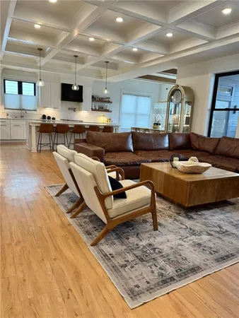 a large white kitchen with kitchen island a stove a sink dishwasher and a refrigerator
