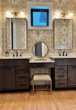 a bedroom with a bed and a flat tv screen on dresser