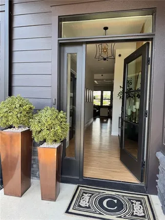 a view of entryway and hall with wooden floor