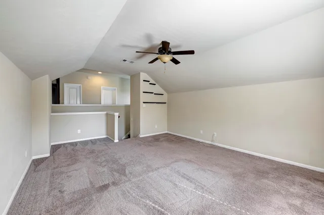 a view of a big room with closet and windows