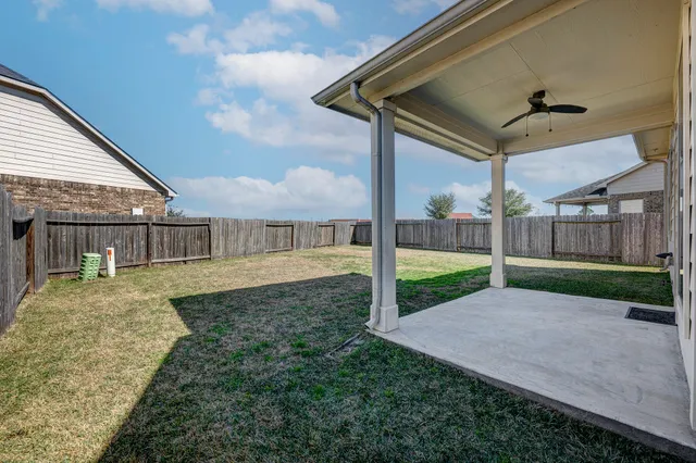 a view of a house with a backyard