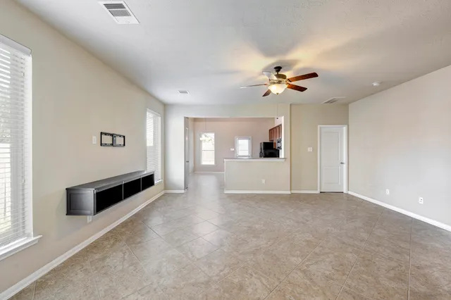 a view of a living room and chandelier fan