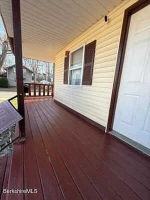 a view of a balcony with wooden floor