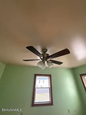 a view of a ceiling fan and a window