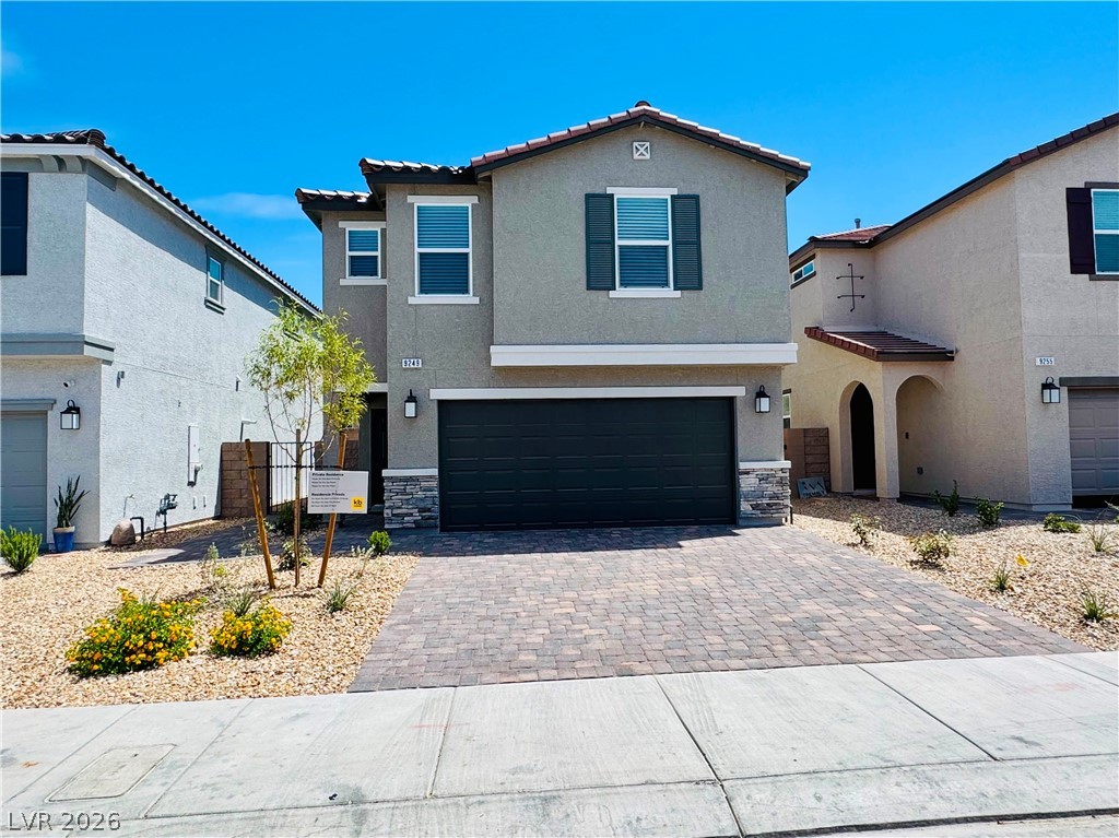 9249 Innot Avenue Las Vegas, NV 89148 - Photo 1 of 24 A well-maintained facade features a paved driveway and low-maintenance desert landscaping.