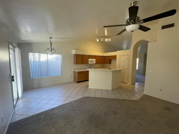 a view of a kitchen with a sink and a refrigerator