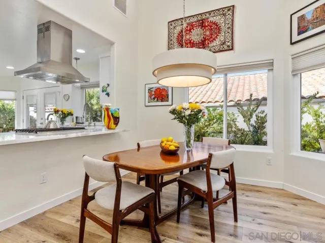 a dining room with furniture and a potted plant