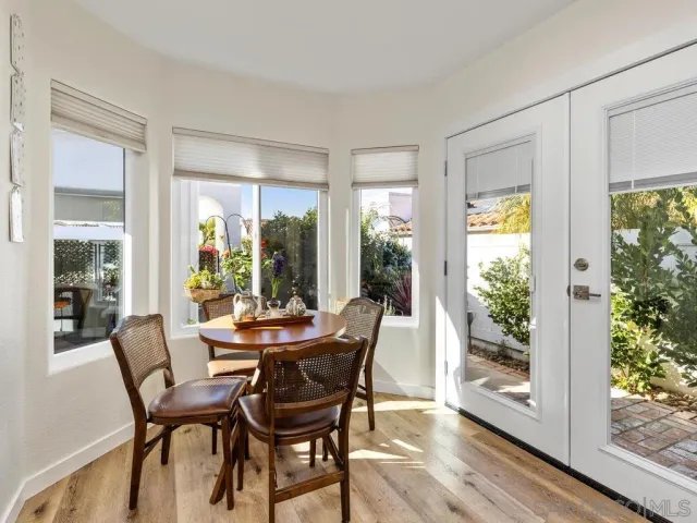 a dining room with furniture window and wooden floor
