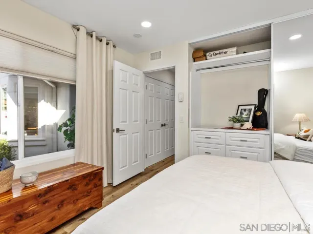 a bedroom with a large bed and a mirror