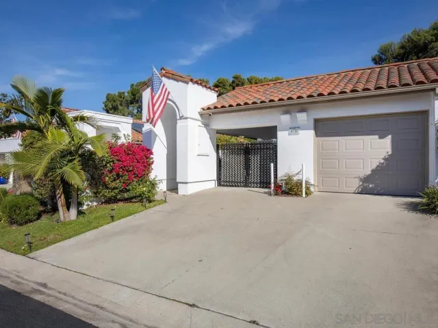 a view of a house with a garage and entertaining space