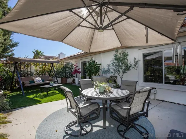 a view of a patio with a table and chairs