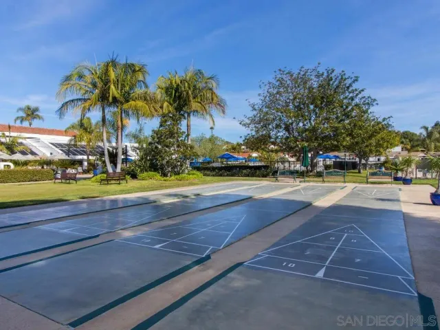 a view of yard with swimming pool and green space