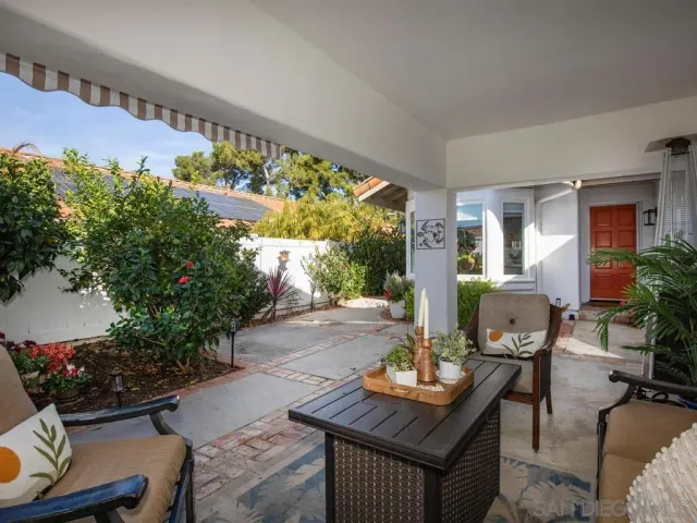 a view of a patio with table and chairs potted plants with wooden floor