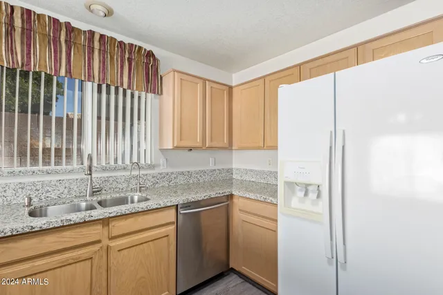 a kitchen with stainless steel appliances granite countertop a sink and a cabinets