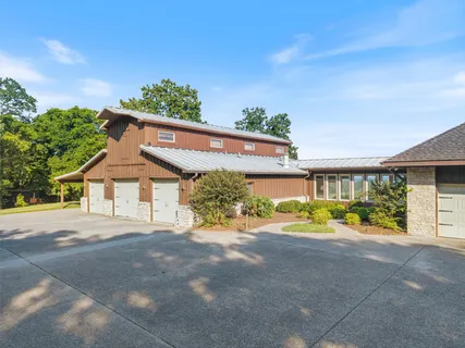 a front view of a house with a yard and a garage