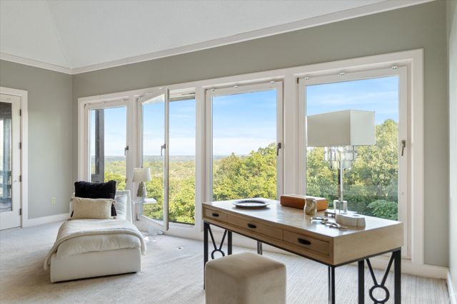 a view of a livingroom with furniture and a large window
