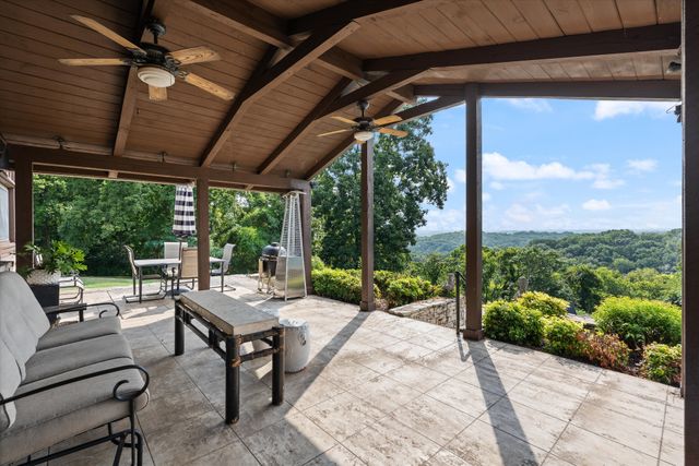 a patio with yard glass top table and chairs