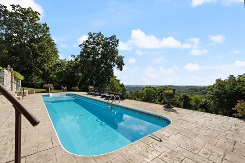 a view of a swimming pool with a yard
