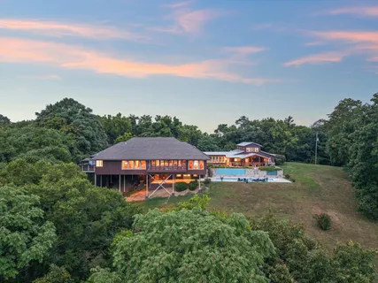 a view of a house with a yard and sitting area