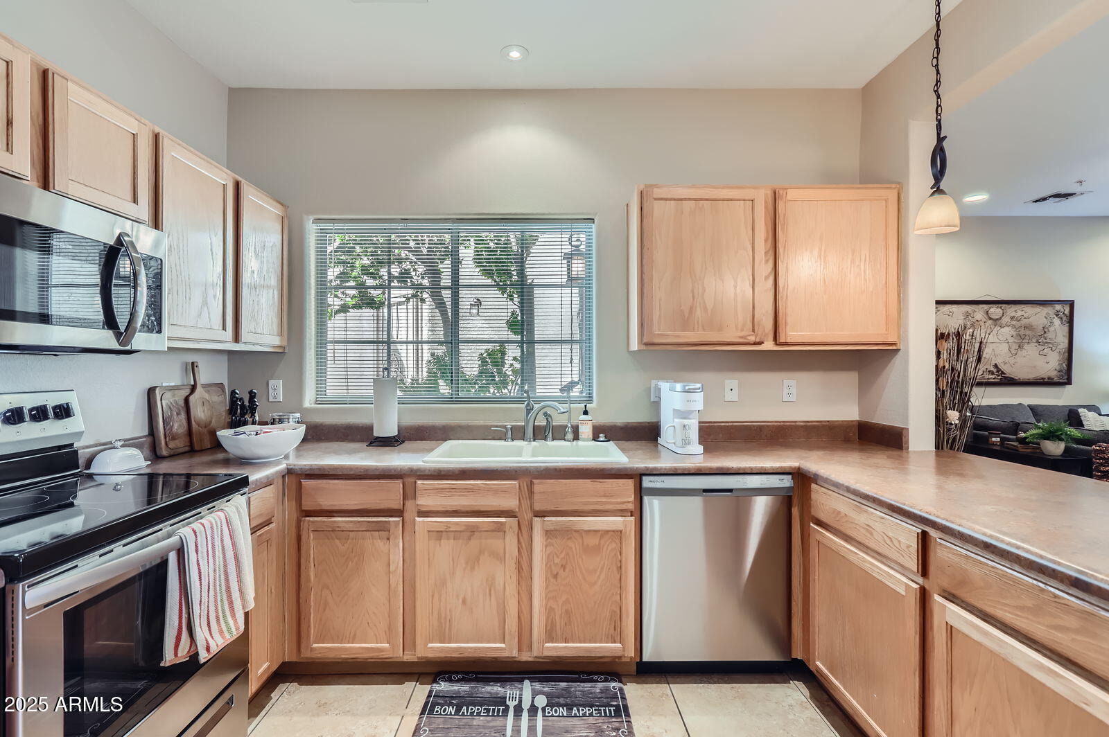 2801 North Litchfield Road, Unit 65 Goodyear, AZ 85395 - Photo 12 of 30 a kitchen that has a sink a stove and cabinets