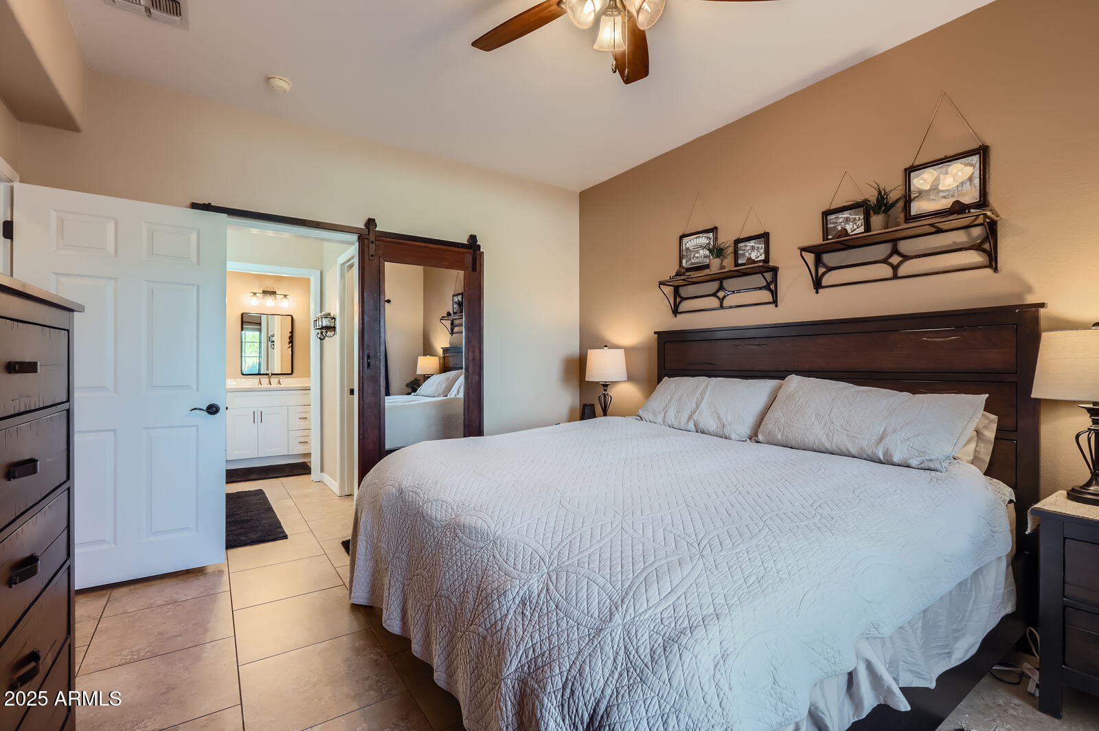 2801 North Litchfield Road, Unit 65 Goodyear, AZ 85395 - Photo 14 of 30 a bedroom with a bed and a chandelier