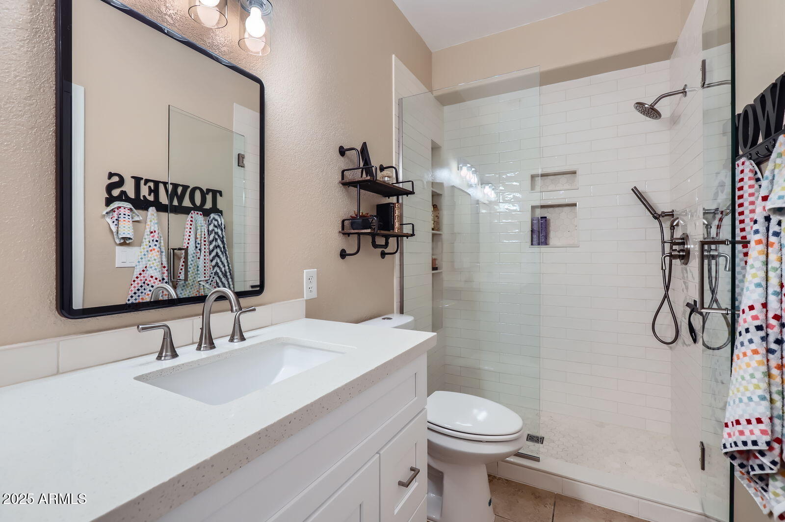 2801 North Litchfield Road, Unit 65 Goodyear, AZ 85395 - Photo 18 of 30 a bathroom with a sink a toilet and shower