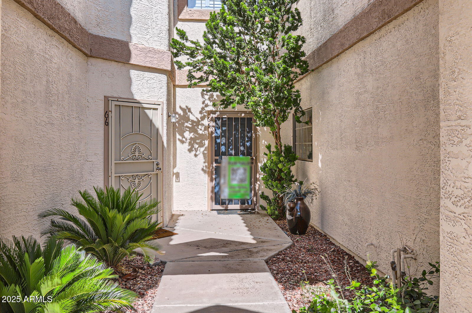 2801 North Litchfield Road, Unit 65 Goodyear, AZ 85395 - Photo 28 of 30 a view of a entryway with flower plants