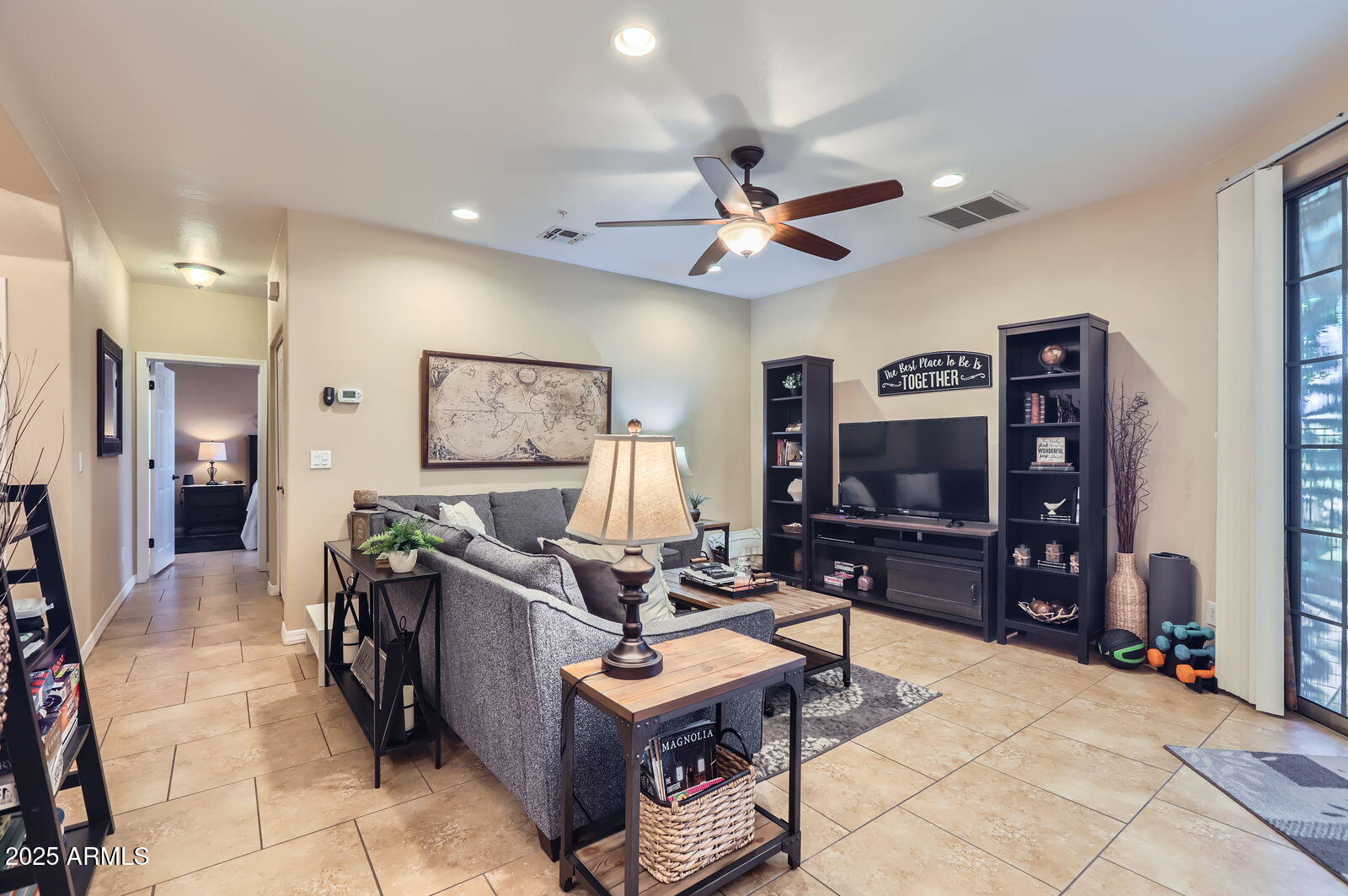 2801 North Litchfield Road, Unit 65 Goodyear, AZ 85395 - Photo 4 of 30 a living room with furniture and a flat screen tv