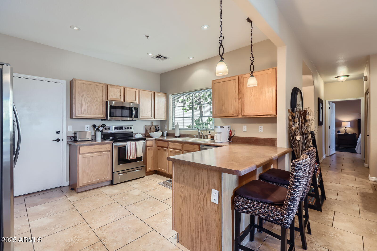 2801 North Litchfield Road, Unit 65 Goodyear, AZ 85395 - Photo 8 of 30 a kitchen with a sink a counter top space stainless steel appliances and cabinets