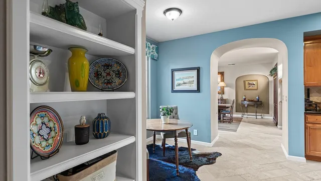 a room with furniture and two windows