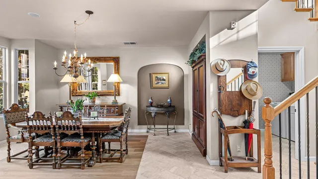 a living room with furniture a bookshelf and appliances