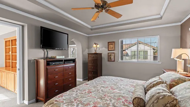 a view of a small yard in front of a house with large trees and plants