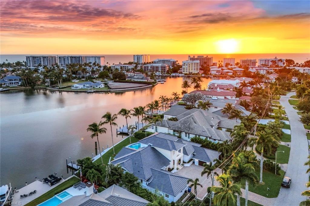 400 Springline Drive Naples, FL 34102 - Photo 2 of 37 Aerial view at dusk of a water view