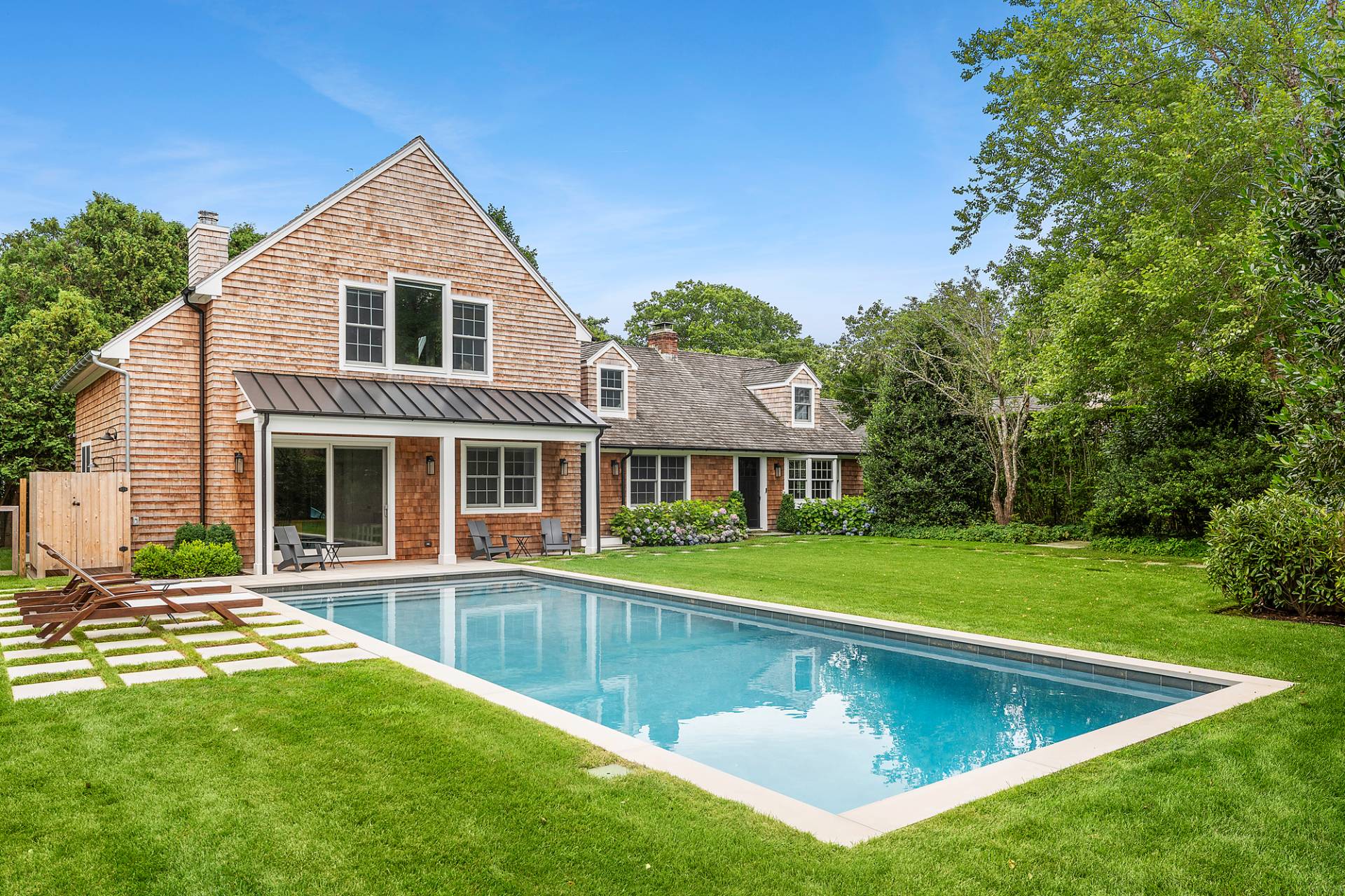 50 Sherrill Road East Hampton, NY 11937 - Photo 1 of 20 a view of a house with a swimming pool