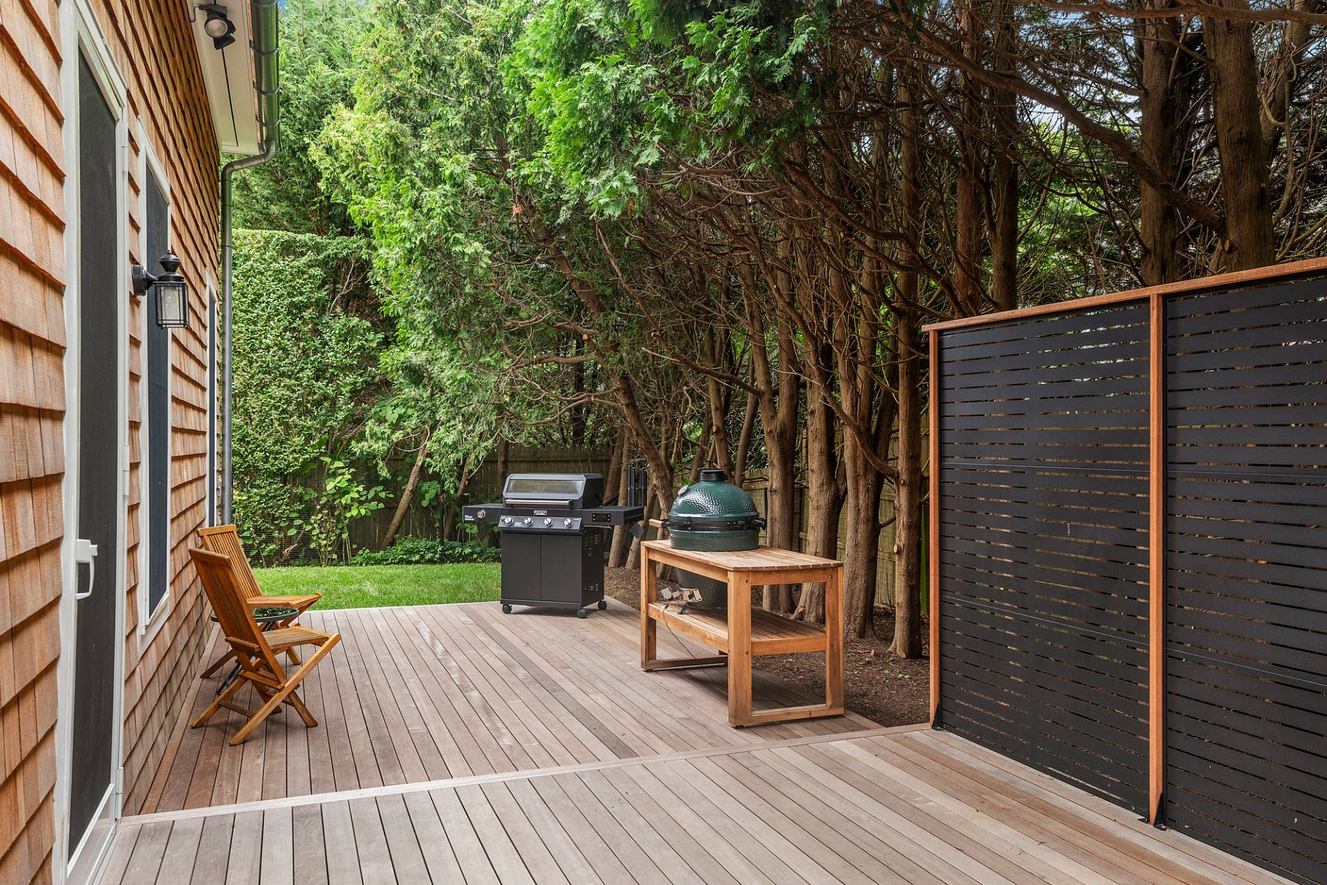 50 Sherrill Road East Hampton, NY 11937 - Photo 20 of 20 a view of couches on the deck with wooden floor and fence