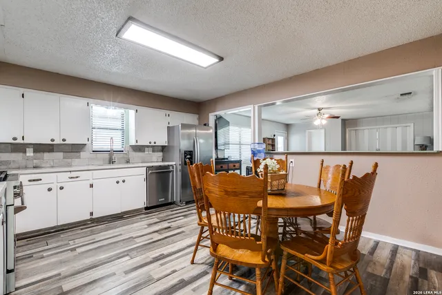 a kitchen with granite countertop cabinets stainless steel appliances and a window