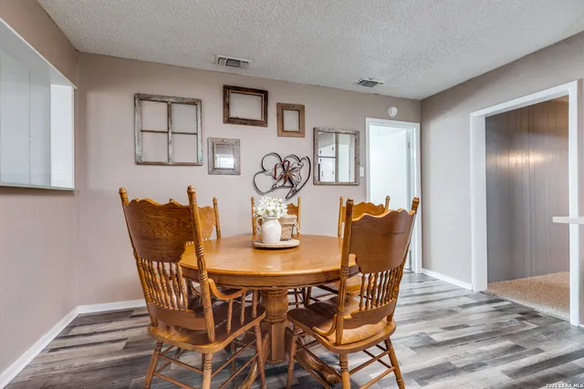 a bedroom with a large bed and a chandelier fan