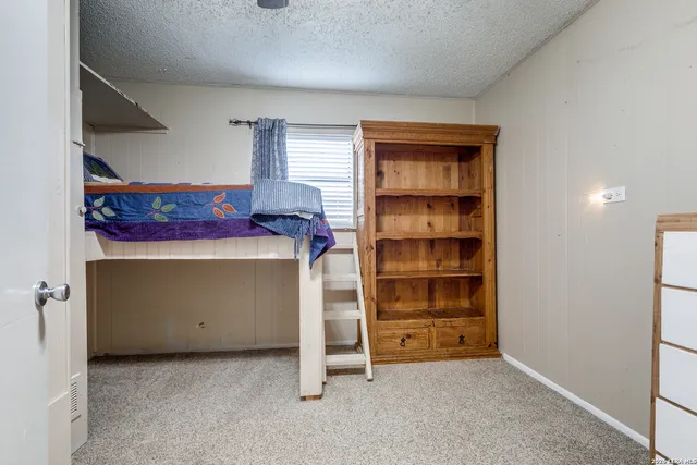 a bedroom with a bed and window