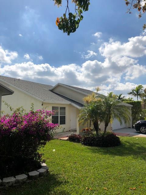 20942 Springs Terrace Boca Raton, FL 33428 - Photo 3 of 35 a front view of a house with a garden