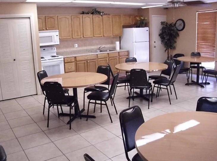 20942 Springs Terrace Boca Raton, FL 33428 - Photo 31 of 35 a kitchen with stainless steel appliances granite countertop a table chairs and a refrigerator