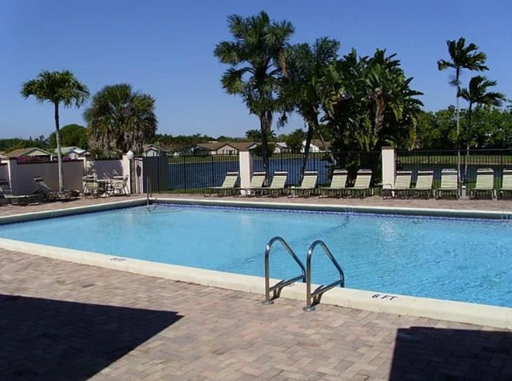 20942 Springs Terrace Boca Raton, FL 33428 - Photo 34 of 35 a house view with a seating space and a garden